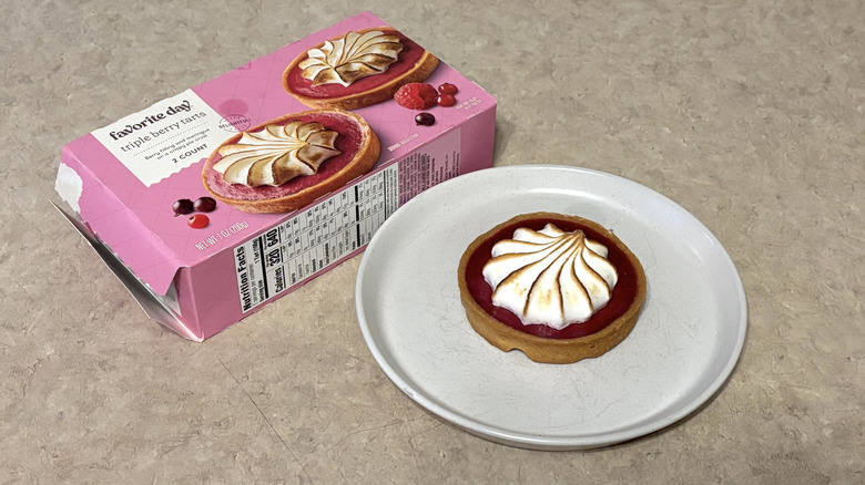 Target's tripple berry tart on a plate next to the pink package box