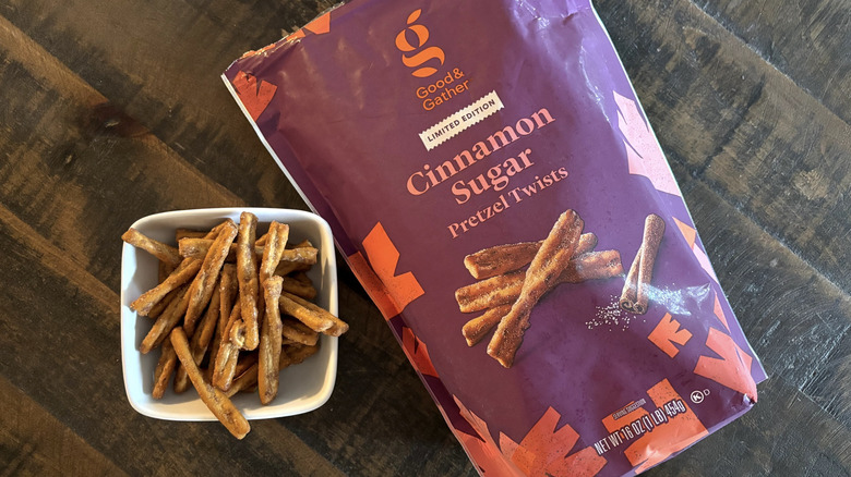 Good & Gather cinnamon sugar seasoned pretzel twists in bag and bowl on a wooden table.