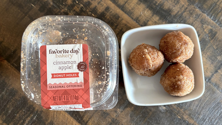 Favorite Day cinnamon apple donut holes in package and bowl on a wooden table.