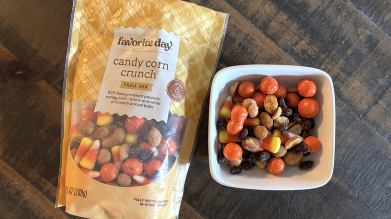 Favorite Day candy corn crunch trail mix in bag and bowl on a wooden table.