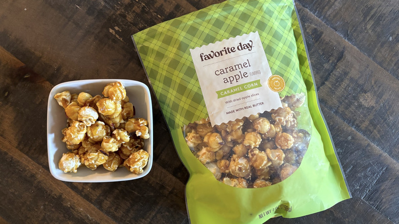 Favorite Day caramel apple caramel corn in bag and bowl on wooden table.