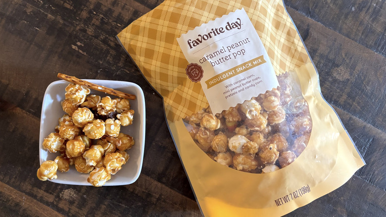 Favorite Day caramel peanut butter pop snack mix in bag and bowl on wooden table.