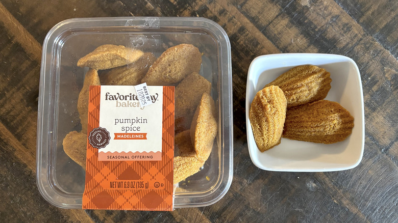 Favorite Day pumpkin spice Madeleines in container and bowl on a wooden table.