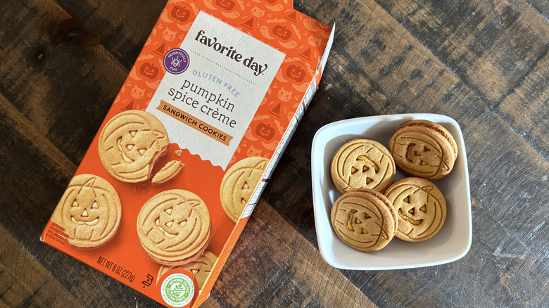 Favorite Day pumpkin spice crème sandwich cookies in box and bowl on wooden table.