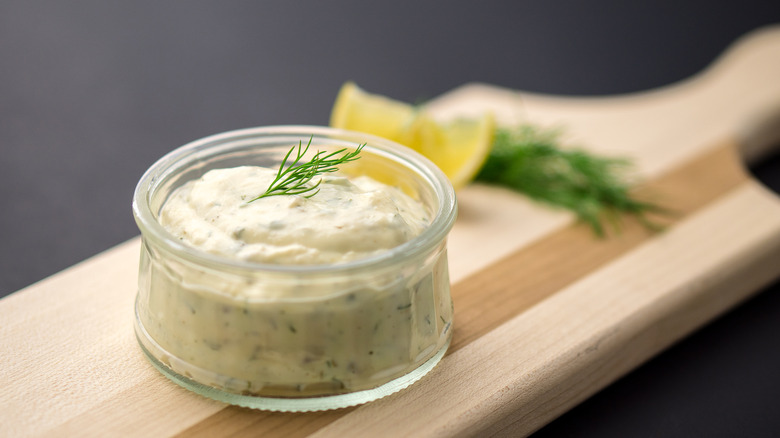 Homemade tartar sauce in a glass jar with dill on top