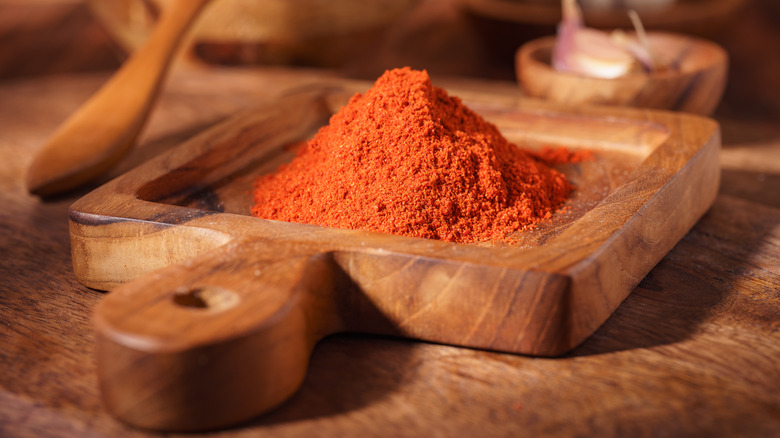 Red ground paprika in a rustic wooden dish