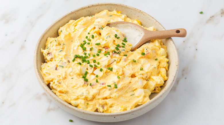 Dish of homemade egg salad on a marble countertop