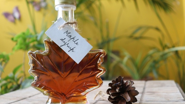 Leaf-shaped maple syrup bottle with pinecone