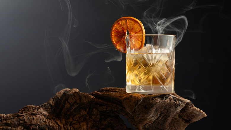 Old fashioned on wood with smoke