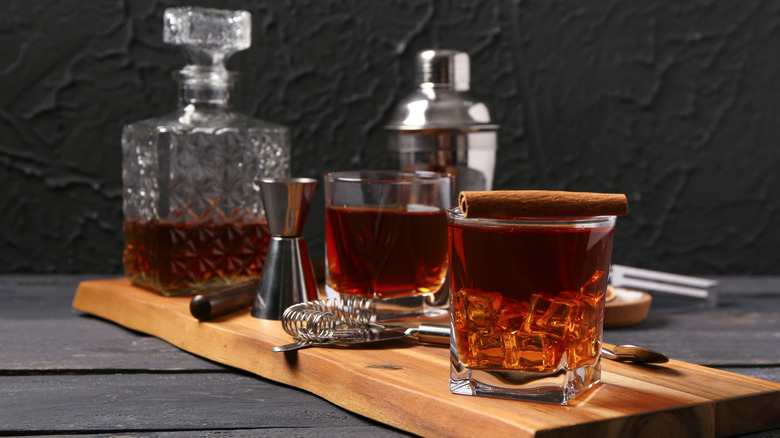 Old fashioned with cinnamon stick and bar tools