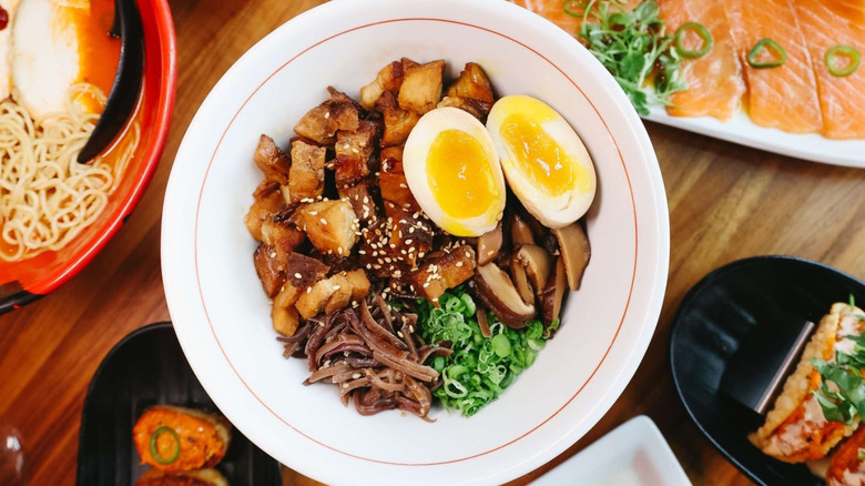 Bowl of Jinya ramen on a table along with other dishes from the restaurant