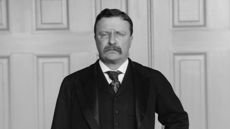 Theodore Roosevelt in a black suit and tie