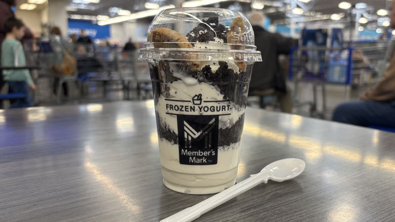 Sam's Club holiday Jingle Cookie Crunch Sundae in plastic cup on cafe table.