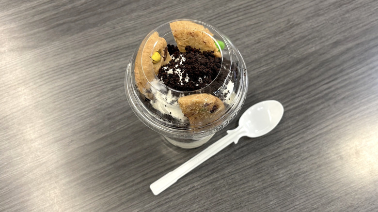 Sam's Club holiday Jingle Cookie Crunch Sundae in plastic cup on cafe table in cafe.