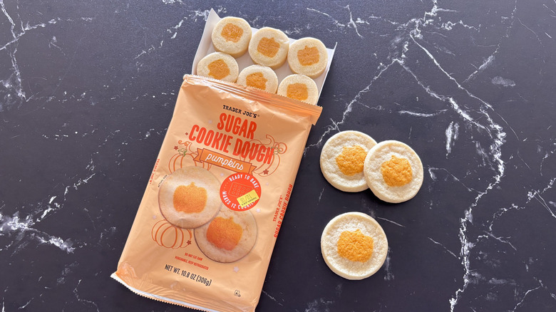 Trader Joe's sugar cookie dough pumpkins package next to baked cookies on countertop