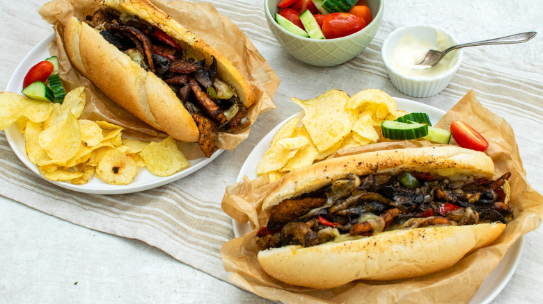 Two tempeh cheesesteaks with chips 