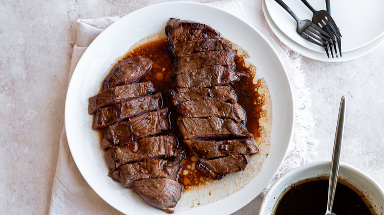 sliced steak on white plate