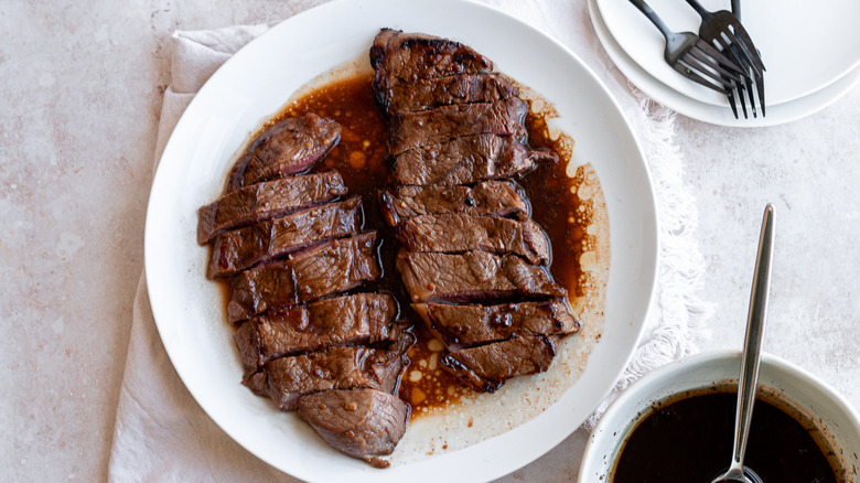 sliced steak on white plate