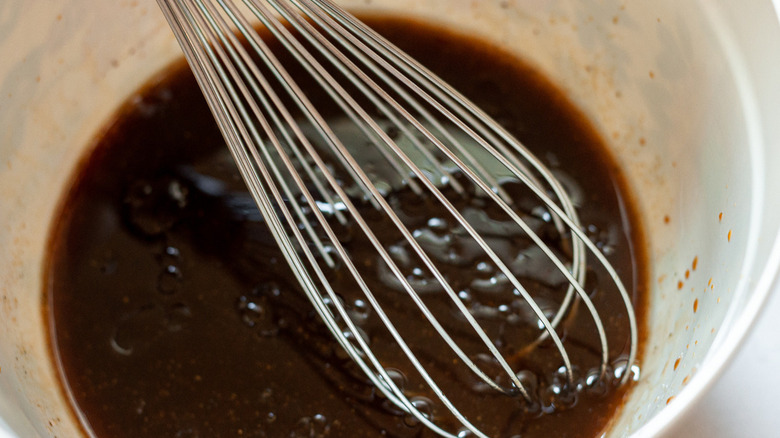 whisking steak marinade in bowl