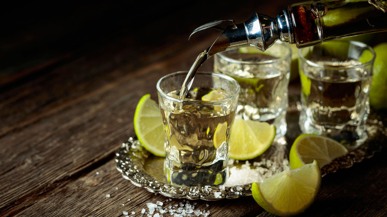 Tequila being poured into a shot glass
