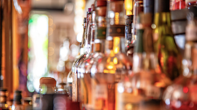 A selection of liquor bottles on display behind a bar.