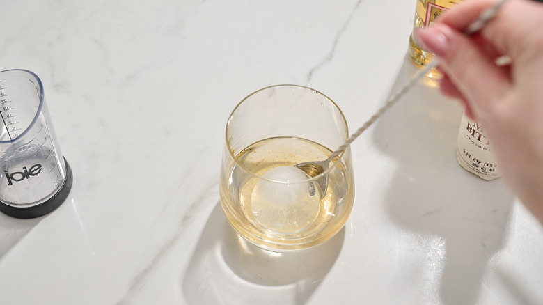 stirring tequila with a spoon