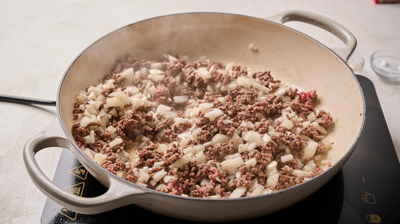 cooking the aromatics with the beef in a skillet