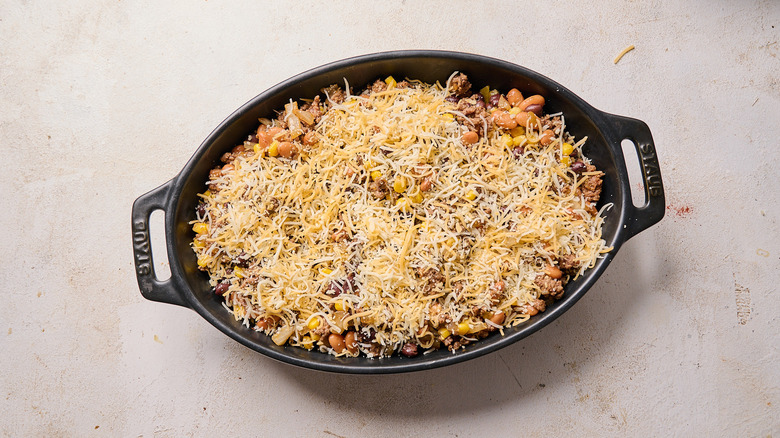 cheese sprinkled onto casserole