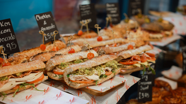 rows of deli sandwiches behind a counter display