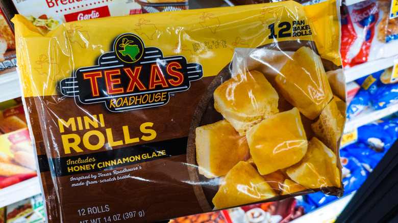 Bag of Texas Roadhouse frozen mini rolls in grocery store aisle