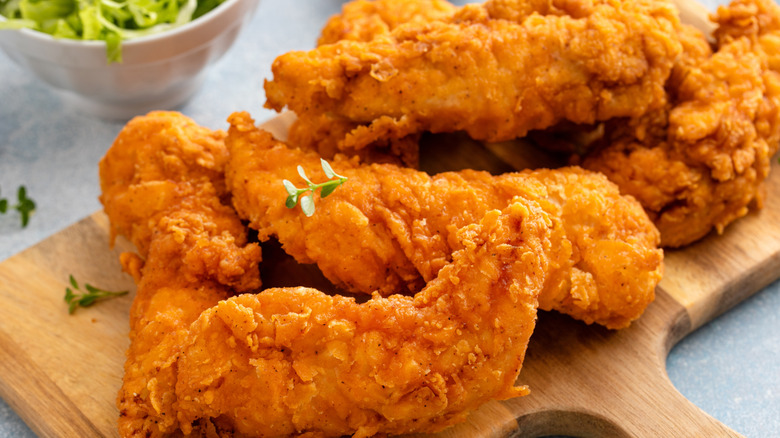 chicken tenders on a wood board