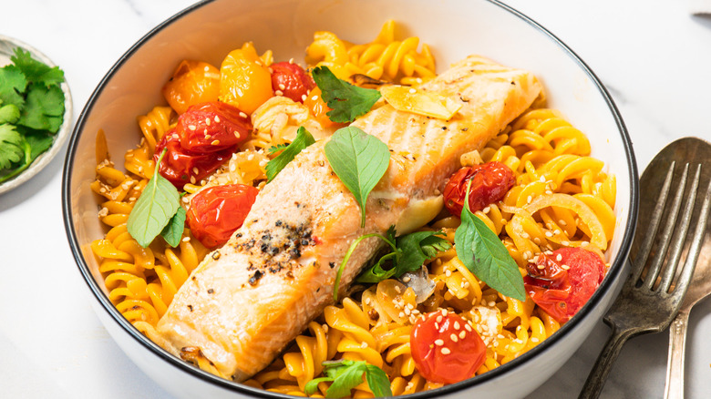 One bowl of Thai curry pasta with salmon.