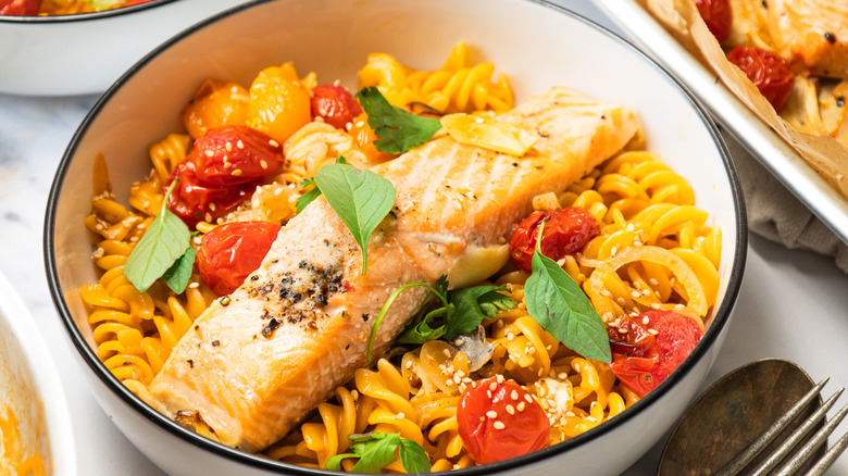 One bowl of Thai curry pasta with blistered tomatoes and salmon.