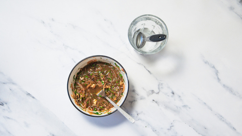 Dipping sauce and water alongside it