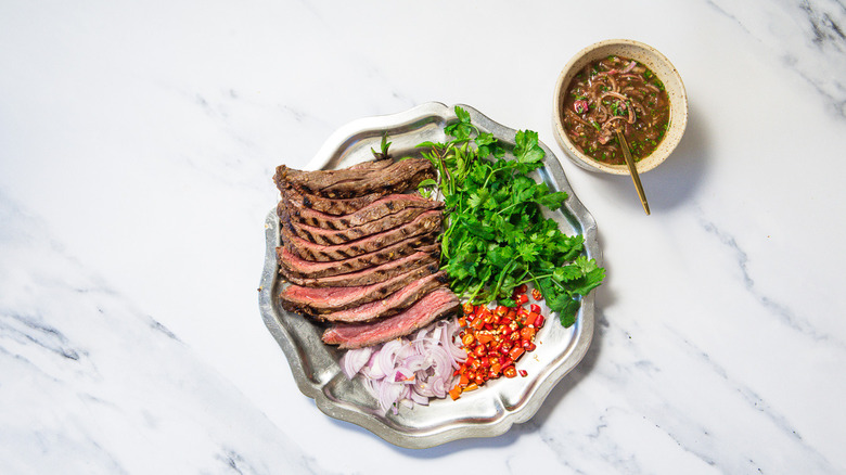 Presented steak with herbs and toppings