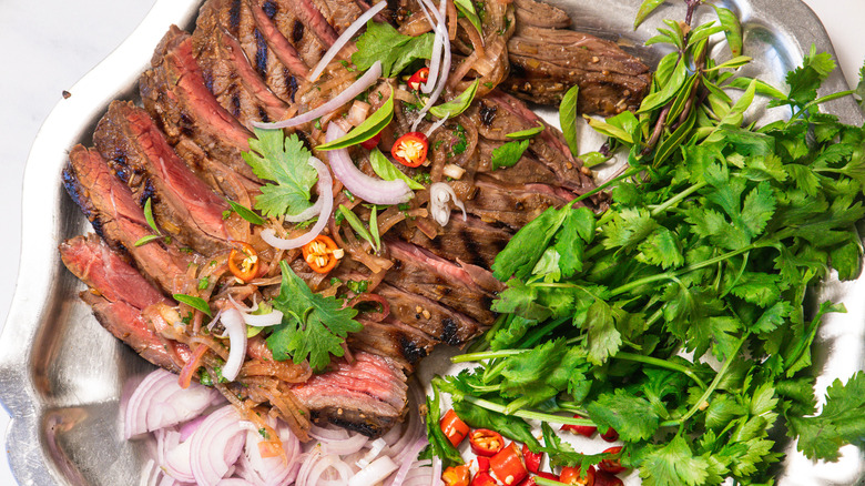 Close up on steak with herbs and toppings