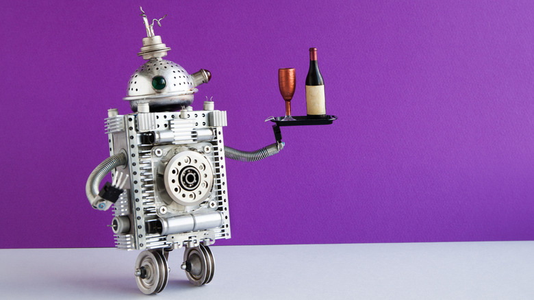 Robot holding a tray of wine