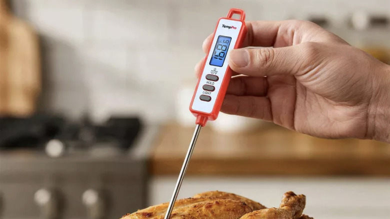 Mini thermometer reading chicken internal temperature
