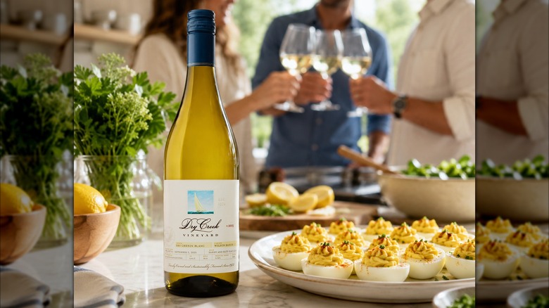 bottle of white wine with deviled eggs