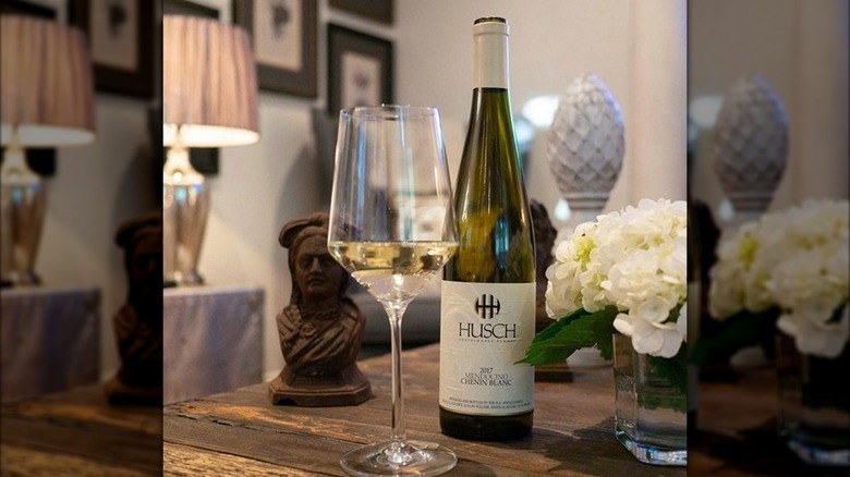 bottle and glass of wine on table