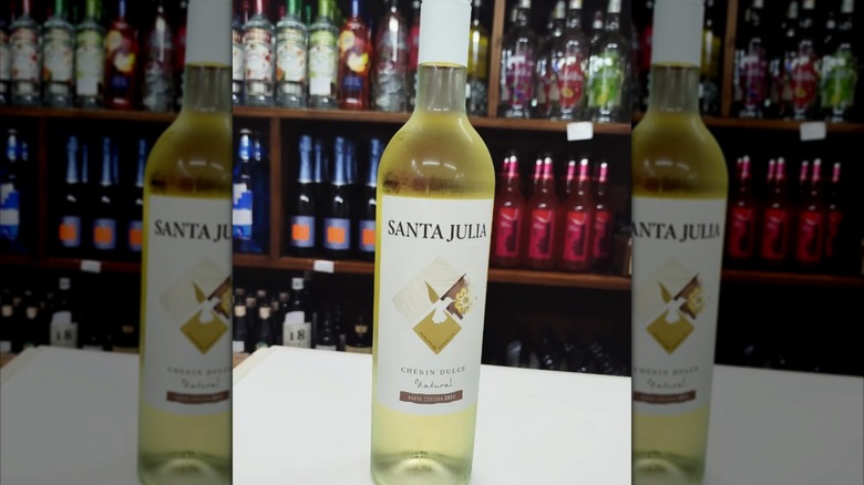 bottle of white wine with wine shop background