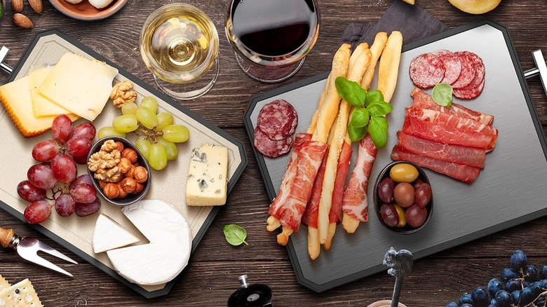 An overhead shot of two cutting board full of food, showcasing the two different sides