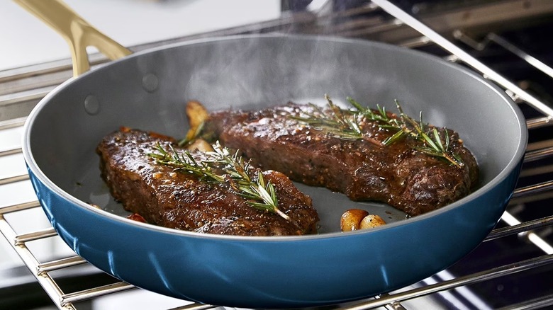 Marine blue GreenPan on oven rack with rosemary steaks