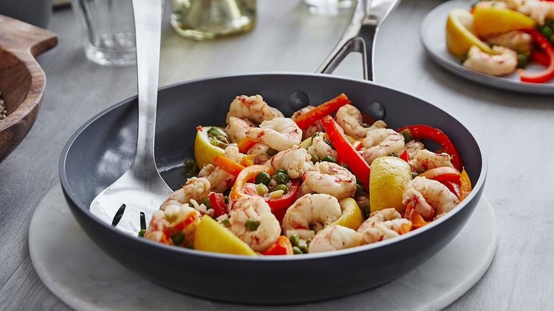 Shrimp and veggies in grey ceramic Valencia Pro GreenPan being served on tabletop