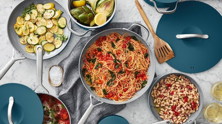 Italian food on countertop with various peacock Member's Mark modern ceramic pans and frying pans