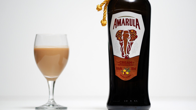 A glass and bottle of Amarula
