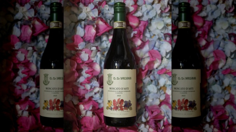 bottle of wine on flower petals