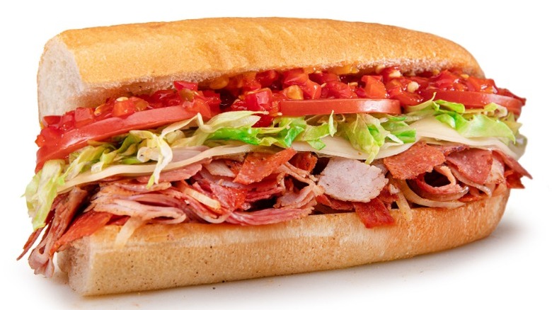 Half a Jersey Mike's Hot Italian sub featuring Tomatoes, hot peppers, and lettuce
