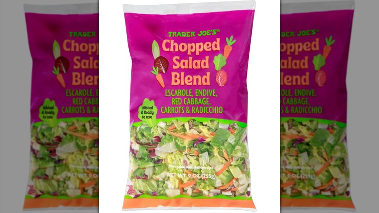 Trader Joe's Chopped Salad Blend with carrots and various greens on white background