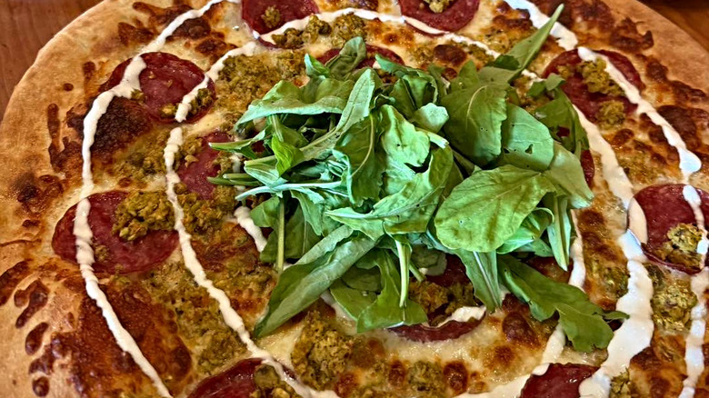 Pizza topped with arugula at Biga Pizza